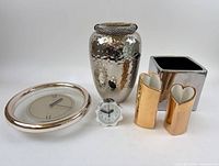 Group shot of all six metallic decorative objects