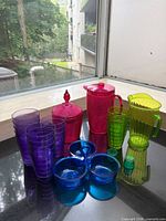 Group view of entire colourful plastic drinkware set