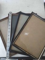 Top view of three stacked frames next to ruler showing size and finishes