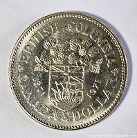 Reverse of 1971 British Columbia Canadian dollar showing shield, dogwood, inscriptions BRITISH COLUMBIA CANADA DOLLAR 1871-1971