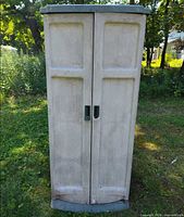 Front view of closed beige plastic shed