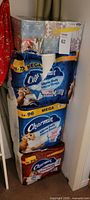 Full stack of Charmin toilet paper packs and Scotties tissue boxes