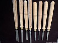 Full view of eight chisels side-by-side showing handles and blades