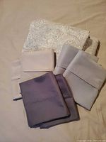 Stacked sheets with six pillowcases in front