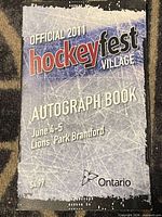 Front cover of 2011 Hockeyfest Village autograph book showing title, date, venue and $4.99 price