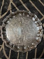 Full view of round engraved tray showing scalloped edge