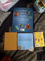 Back covers of Voyage Into the Deep, yellow Judy Blume hardcover, back of Same But Different Too, back of Extreme Scooby-Doo