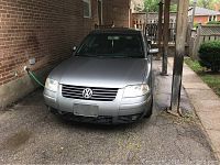 Front exterior view of gun metal grey Passat showing grille, headlights and hood