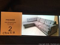 Photo showing two-piece blue-grey sectional couch with microfiber suede upholstery and tufted back seating.