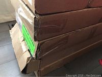 Stack of cardboard boxes containing flooring cartons