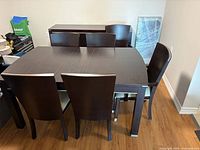 Dining table with all six chairs arranged around it