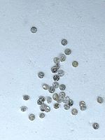 Group of loose round diamonds scattered on background