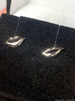front view of both lips earrings on display pad