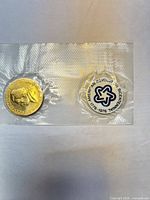 Front view of sealed medal and button in packaging