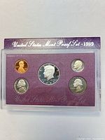 Front view of sealed proof set showing all five coins and outer sleeve