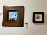 Both framed artworks side by side on wall