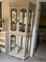 Full view of display cabinet showing upper and lower glass doors and shelves