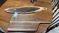 Both wooden charcuterie boards on table