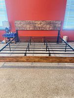 Full view of king bed frame showing headboard, footboard and metal slat structure