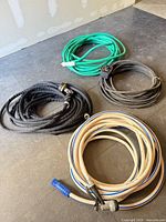 All four coiled hoses displayed on floor