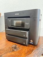 Angled front view of Epson WorkForce Pro WF-4833 printer showing touchscreen and paper trays