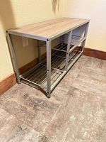 Full view of bench showing woodgrain top, metal frame, wire shelves