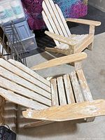 Both wooden Adirondack chairs side by side showing overall design and weathered finish