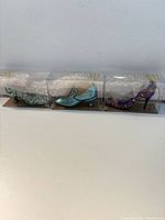 Front view showing all three boxed shoe ornaments