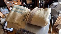 Two folded wool blankets on table showing patterns and thickness