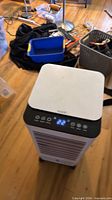 Front view of cooler showing controls, display lit at 22°C, front grill and caster base