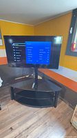 Front view of Samsung TV on stand with on-screen menu displayed