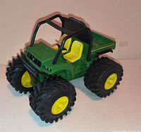 Front three-quarter view of toy showing roll cage, grille, wheels