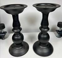 Front view of both 9 in black metal candle holders