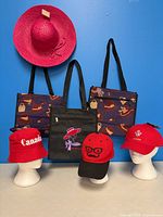 Group shot of three tote bags and four hats
