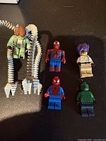 All five minifigures laid out on surface