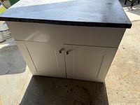Front view of white cabinet with countertop