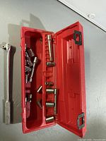Open red case with sockets and extensions visible