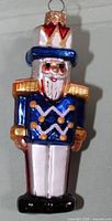 Front view of blown glass nutcracker ornament