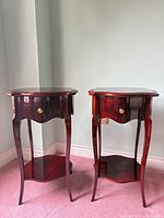 Both matching mahogany side tables front view