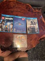 Front view of three cased Wii U games and one loose disc