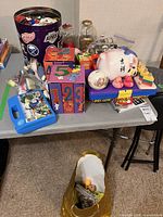 Overall lot showing tin of LEGO, piggy bank, gumball machine, carry case, number blocks, rubber duckies