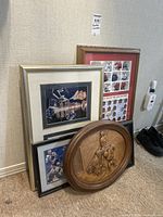 Multiple framed hockey items leaning against wall