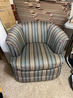 Front view of striped swivel tub chair showing overall design and cushion