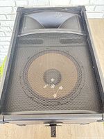 Front view of Nady Thunder ThS-1512 speaker showing grille, woofer, horn