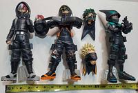 Front view of three stealth-suit figures with alternate heads and measuring tape