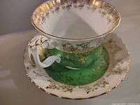 Cup on saucer showing color scheme and decoration