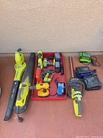 Group shot of all tools, batteries and chargers on floor