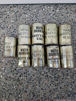 Front view of nine cans showing branding and finish