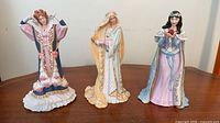 Front view of three Lenox princess figurines on table