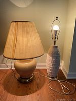 Beige lamp with shade and white lamp side by side
